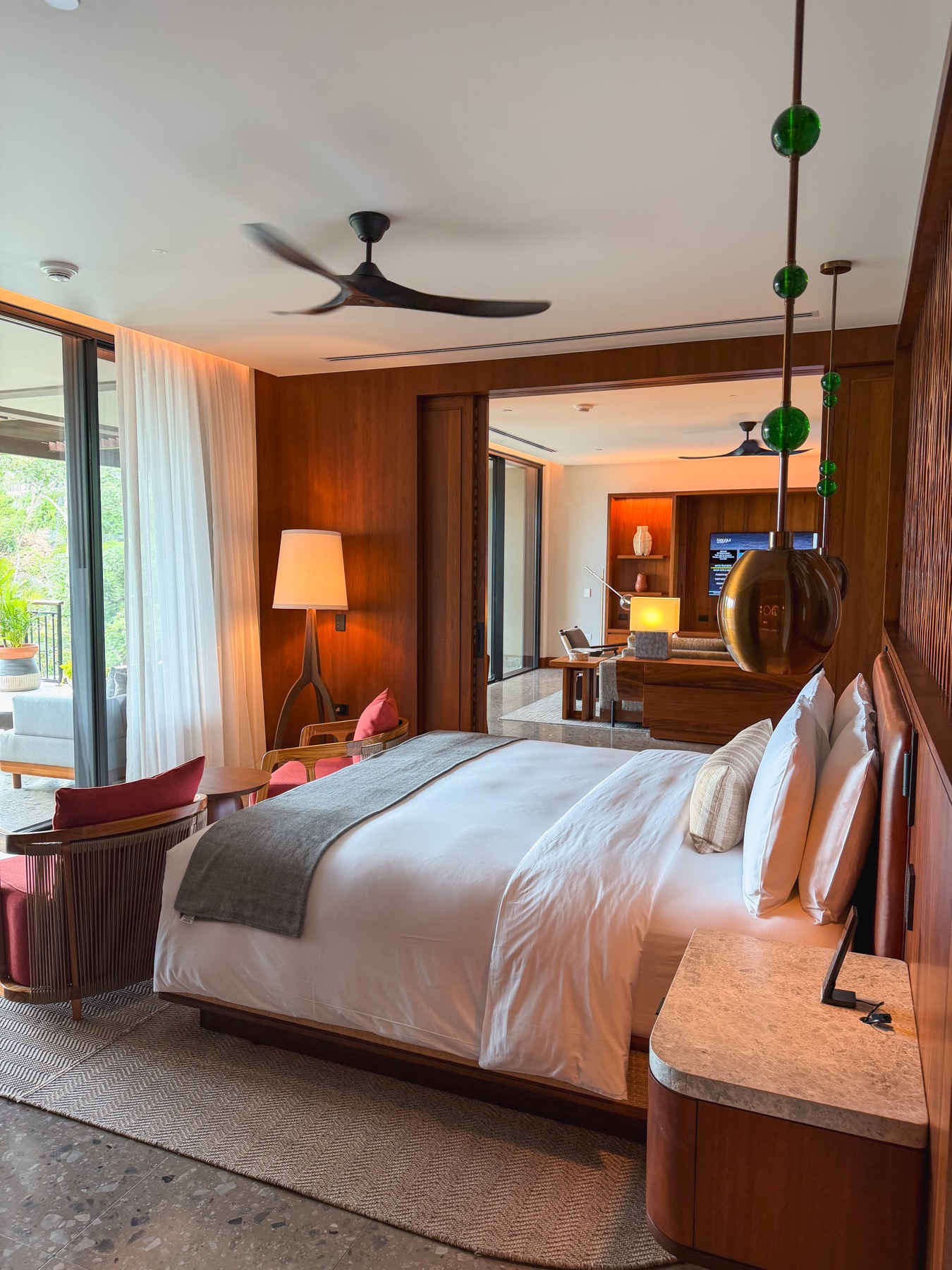 Warm wood luxury hotel suite with a large bed and private terrace